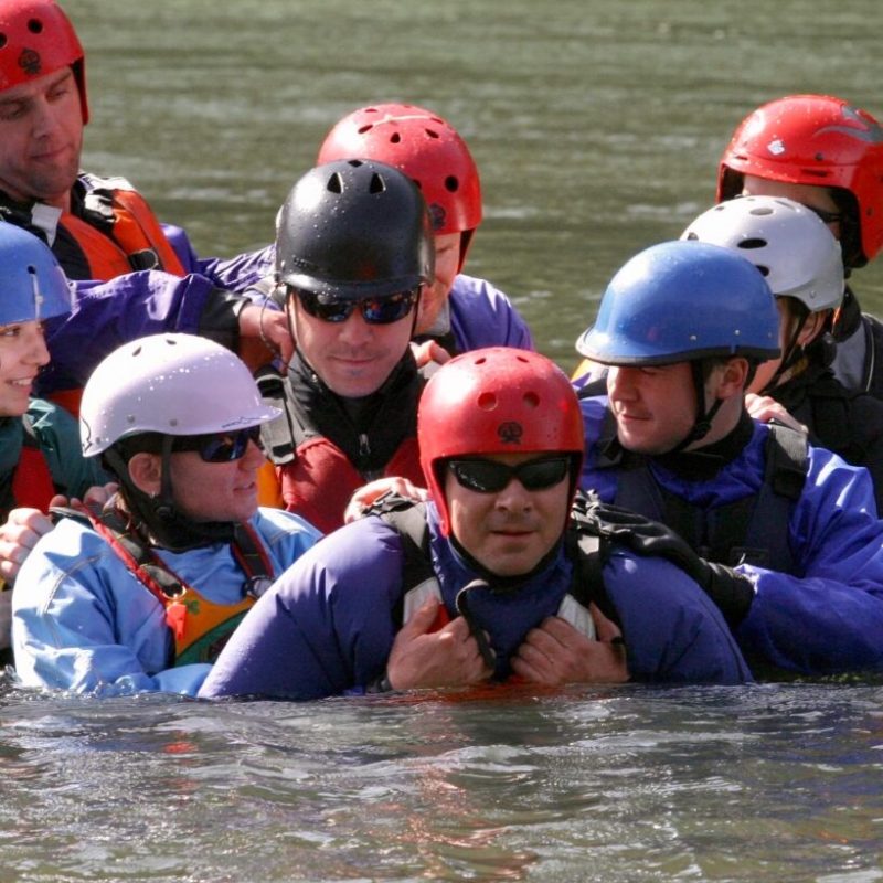 a group of baseball players that are standing in the water
