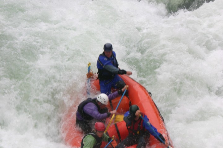 a man riding a wave on a surf board on a body of water