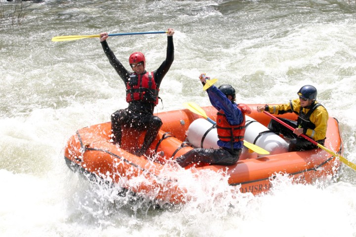 a man riding on a raft in a body of water