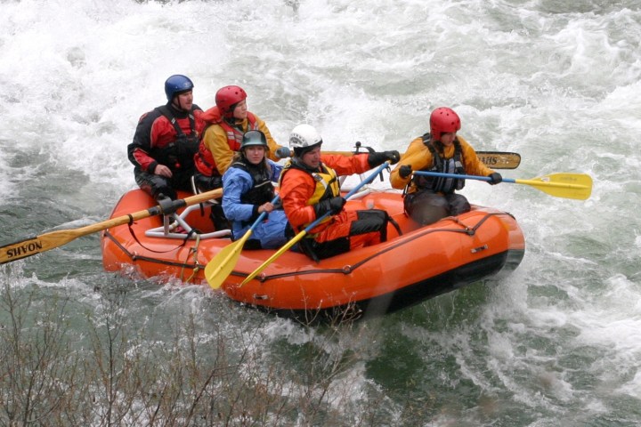 a group of people riding on a raft in a body of water