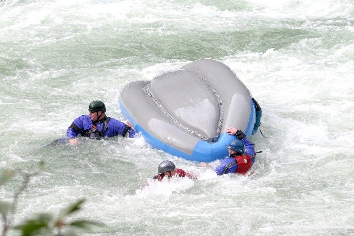a young girl riding a wave on a surfboard in the water