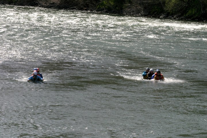 a group of people riding skis on a body of water
