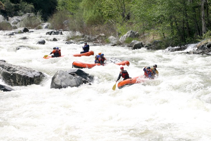 a group of people on a raft in the snow