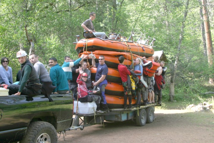 a group of people riding on the back of a truck