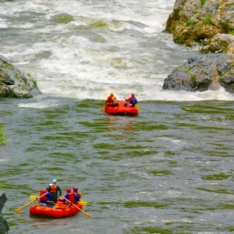 a group of people on a raft in a body of water