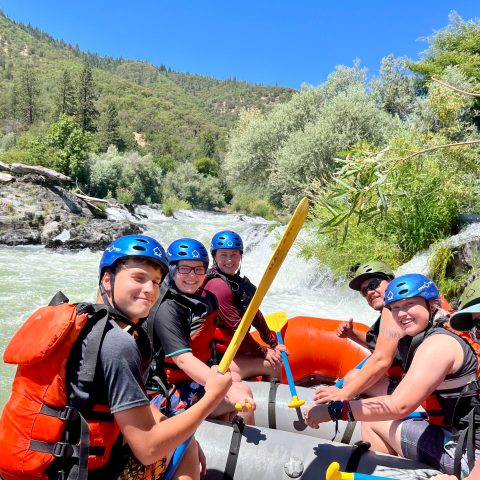 a young boy riding on a raft