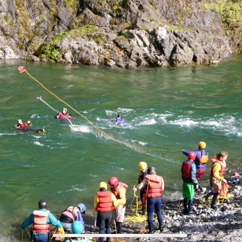 a group of people on a boat in the water