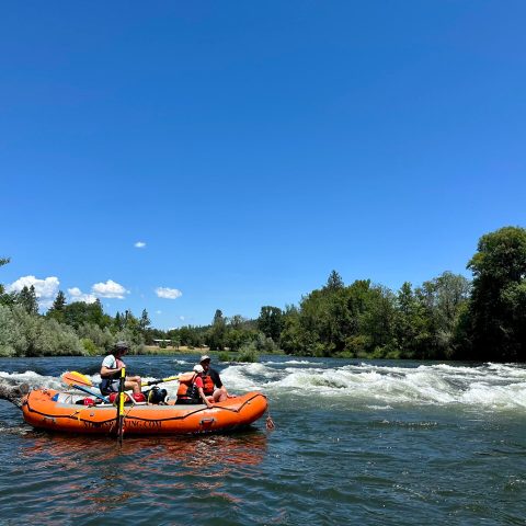 a group of people in a small boat in a body of water