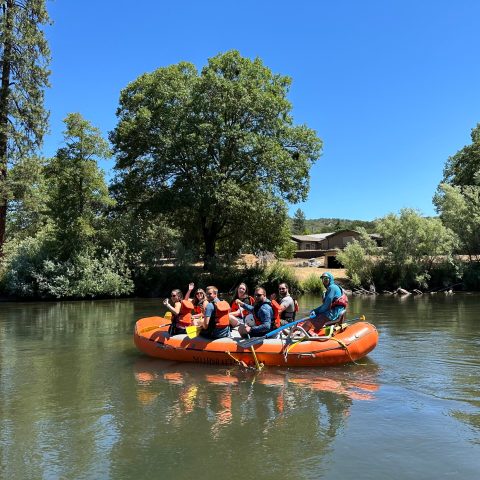 a group of people in a small boat in a body of water