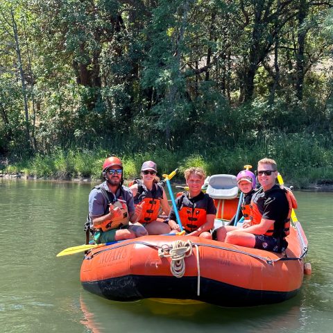 a group of people riding on the back of a boat