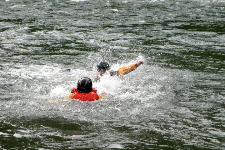 a man riding a wave on top of a body of water
