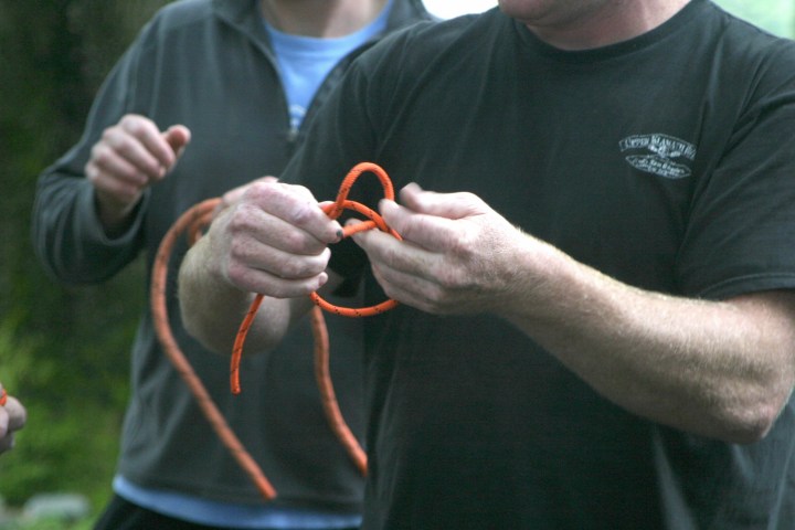 a man holding a glass of orange juice