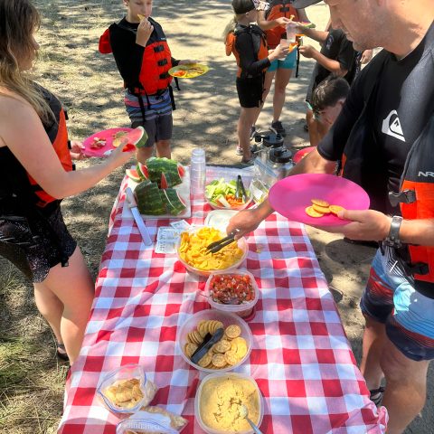 a group of people sitting at a picnic table
