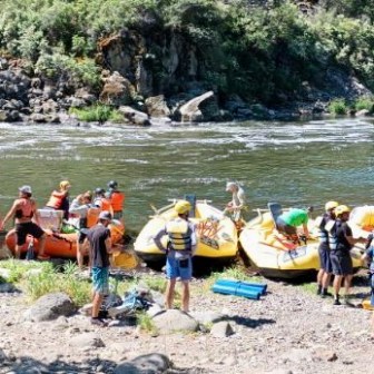 a group of people sitting at a beach
