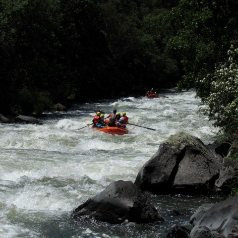 a man riding on a raft in a body of water