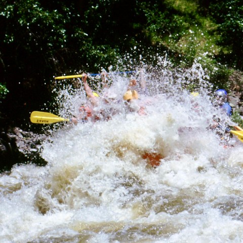 a man riding a wave on top of a body of water