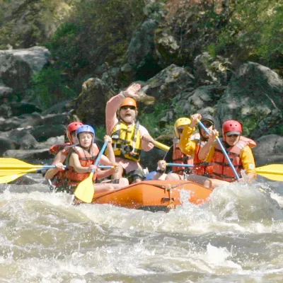 a group of people riding on a raft in the water