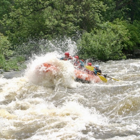 a man riding a wave on top of a body of water