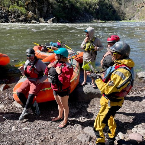 a group of people on a raft in a body of water