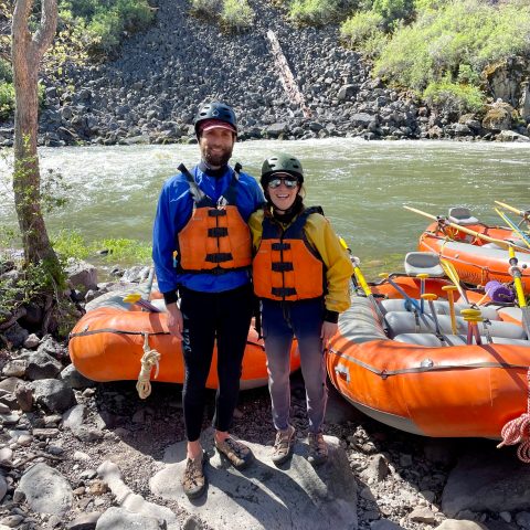 a group of people standing on a raft