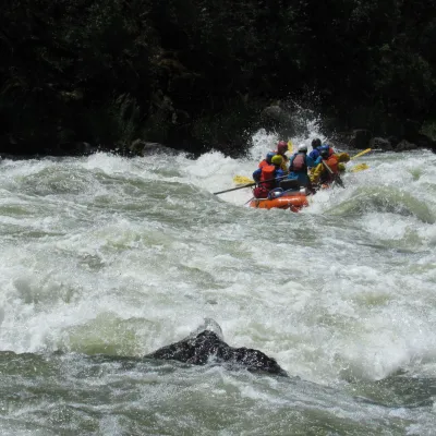 a group of people riding on a raft in a body of water