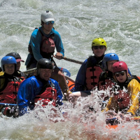 a group of people on a raft in a body of water