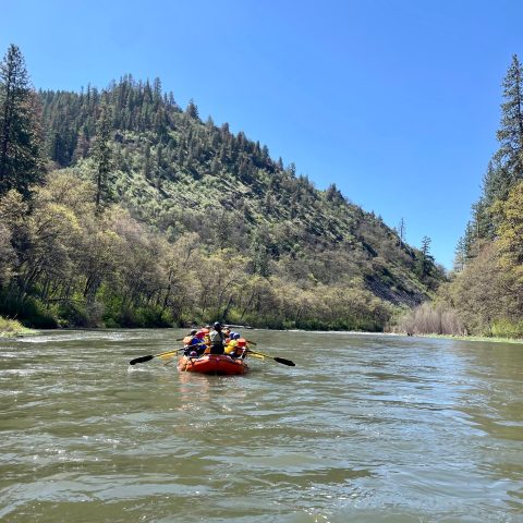a man riding a motorcycle on a raft in a body of water