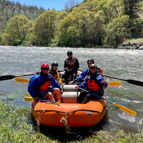 a group of people on a raft in a body of water