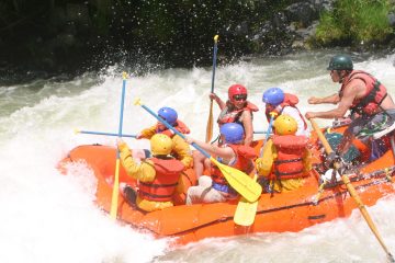 a group of people riding skis on a raft in a body of water