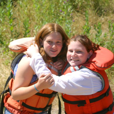 a little girl that is standing in the grass