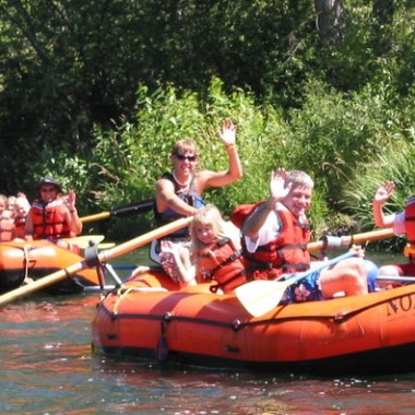 a group of people riding on the back of a boat