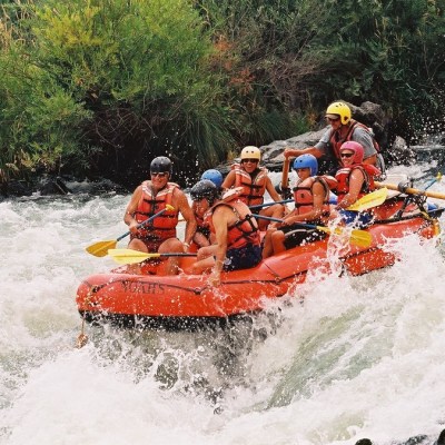 a group of people riding on a raft in a river