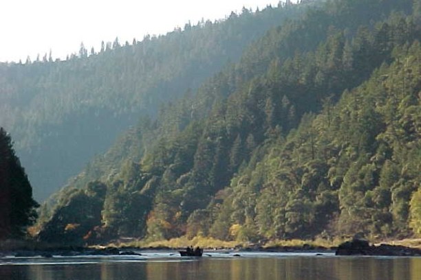 a body of water with a mountain in the background