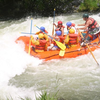 a group of people riding skis on a raft in a body of water