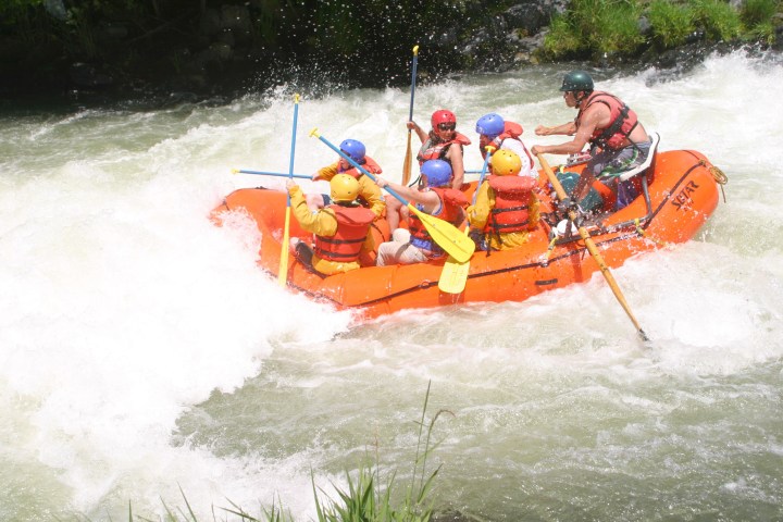 a group of people riding skis on a raft in a body of water