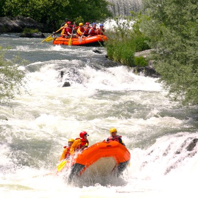 a man riding on a raft in a body of water