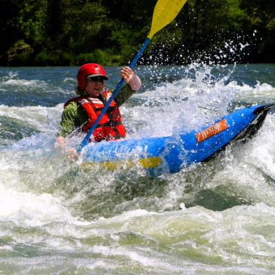a man riding a wave on a surf board on a body of water