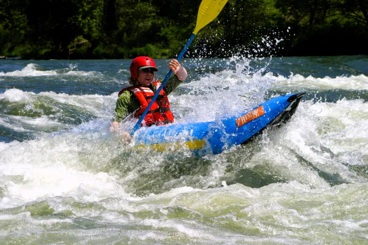 a man riding a wave on a surf board on a body of water