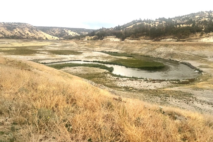 a body of water with a mountain in the background