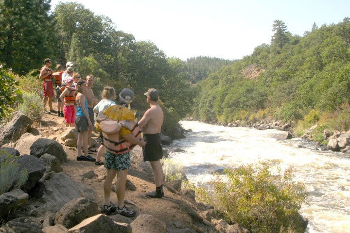 a group of people standing on a rock