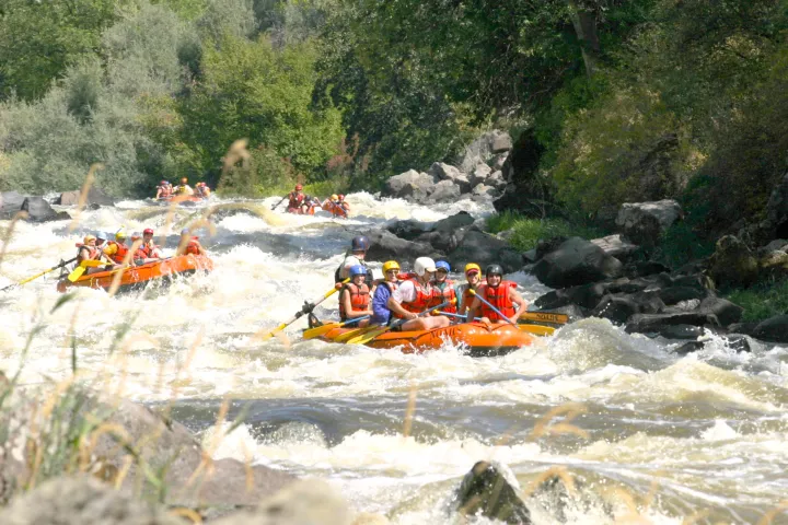 a group of people on a raft in a body of water