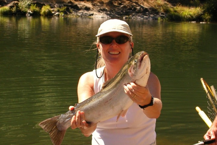 a person holding a fish in the water